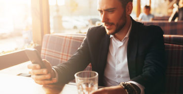 A guy who's a narcissist looking at his phone while the woman who's in the narcissistic relationship with him looks on.
