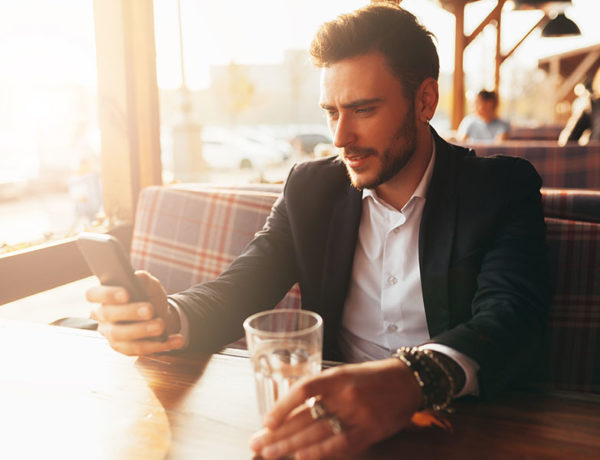 A guy who's a narcissist looking at his phone while the woman who's in the narcissistic relationship with him looks on.