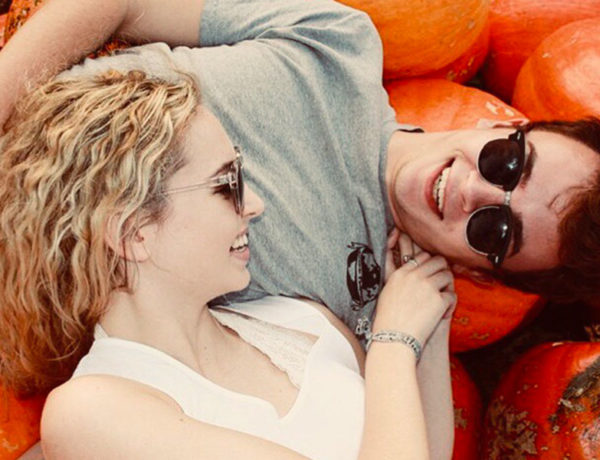 A man and woman trying to establish open relationship rules while talking outside in a pumpkin patch.