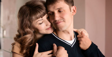 A woman who's a codependent hugging her narcissist partner.