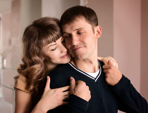 A woman who's a codependent hugging her narcissist partner.