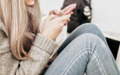 A woman texting on her phone and wondering if he texts me every day does that mean he likes me.