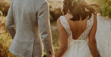 A couple who found out that marriage was right for them holding hands at their wedding.