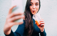 A woman taking a selfie for her online dating photo.
