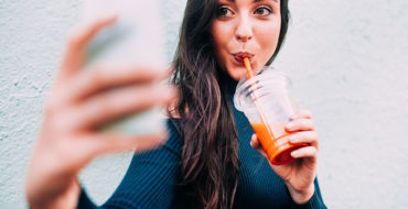 A woman taking a selfie for her online dating photo.