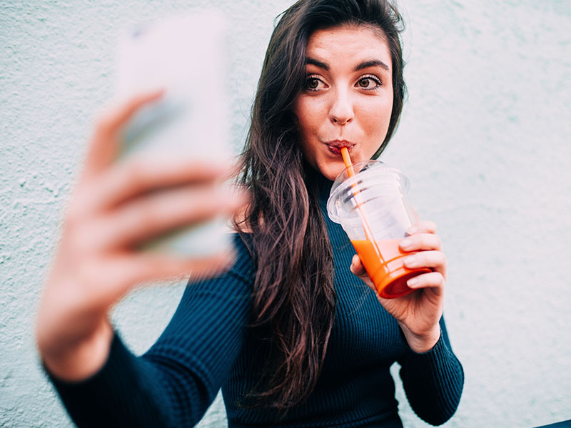 A woman taking a selfie for her online dating photo.