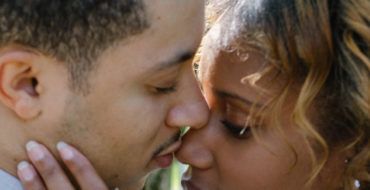 A woman who's wondering how do you know you love someone, kissing her boyfriend and wondering.