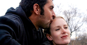 A divorcee dating and kissing his date on the forehead on a hike.