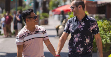 A couple walking down the street during a first date and laughing.
