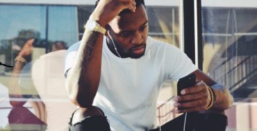 Man looking stressed looking at his phone and working out how to break up with a girl