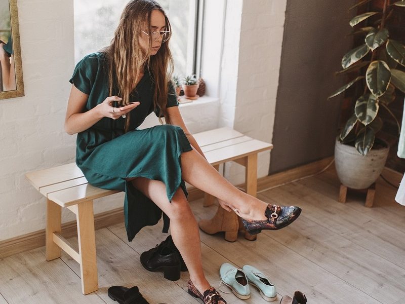 Woman trying on shoes for her first date outfit
