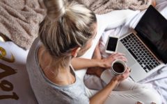 Blonde woman using laptop to meet people on good dating sites