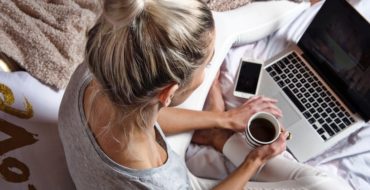 Blonde woman using laptop to meet people on good dating sites